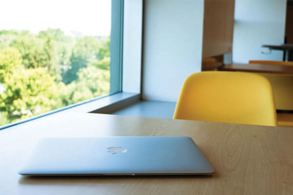 MacBook on a desk in the Discovery Centre.