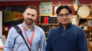 Jacky Chan standing and smiling next to Scouts Canada CEO, Liam Burns