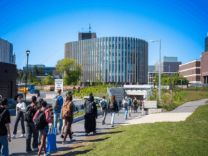 Students walking down a tunnel path towards Campus Avenue.