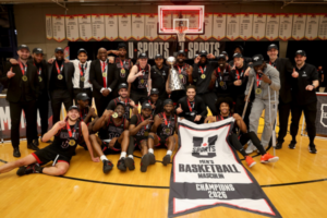 Ravens men's basketball team posing with the U SPORTS national championships medals and banner.