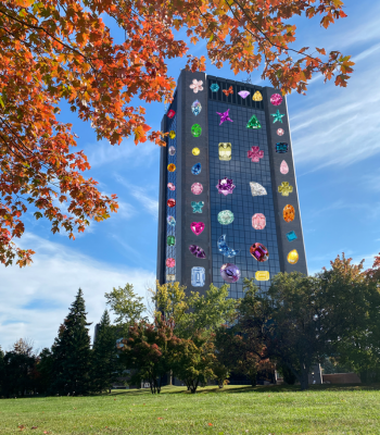 An image of Dunton Tower in fall with gemstone stickers on it.